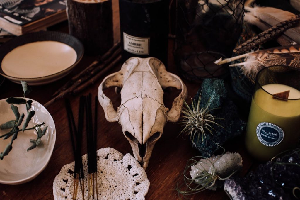 pexels photo 4992863 Eerie setup with skull and candles, evoking a mystical ritual or spooky atmosphere.